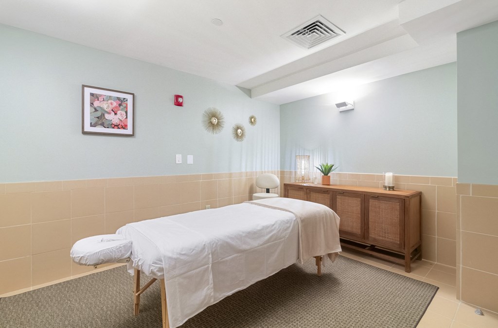 a treatment room with two beds and a wooden dresser  at HIGHGROVE, Stamford, CT, 06901