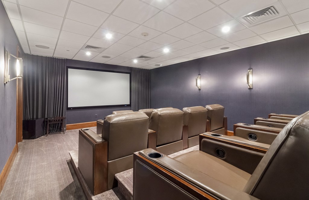 a conference room with leather chairs and a screen on the wall at HIGHGROVE, Stamford, 06901