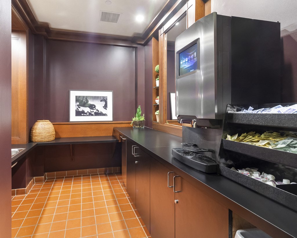 a kitchen with a counter and a tv in a hotel room at HIGHGROVE, Stamford, CT