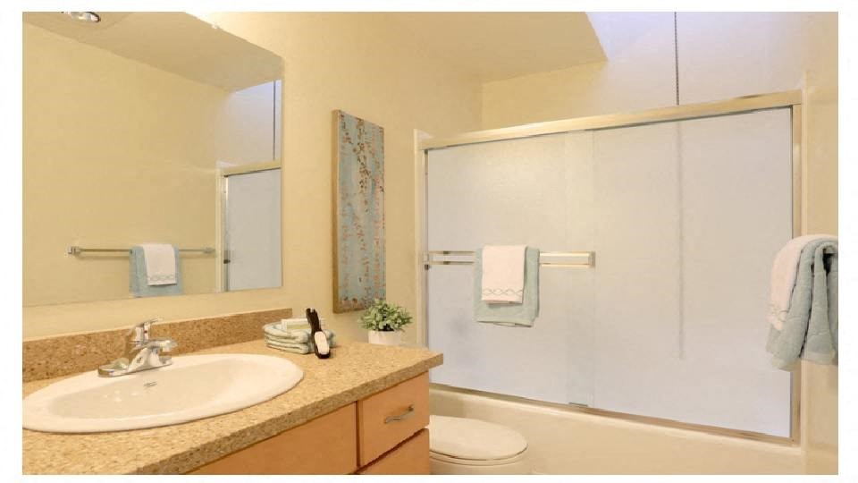 a bathroom with a sink and a shower and a toilet