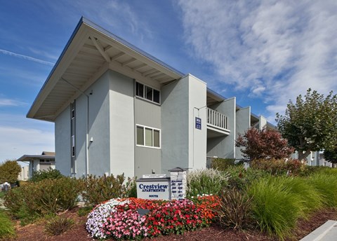 A modern building with a sign that says Crestview in front of it.