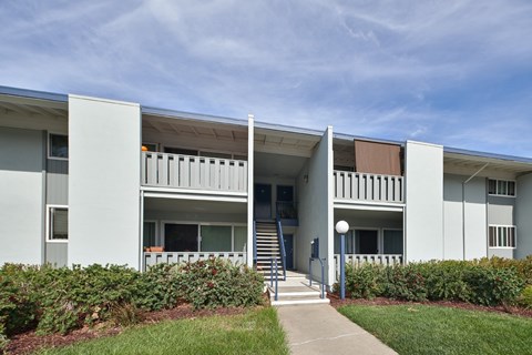 A white building with a blue sky in the background.