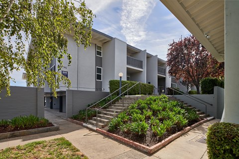 A modern building with a staircase leading to the entrance.