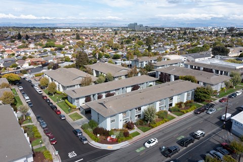 A view of a street with cars and buildings.