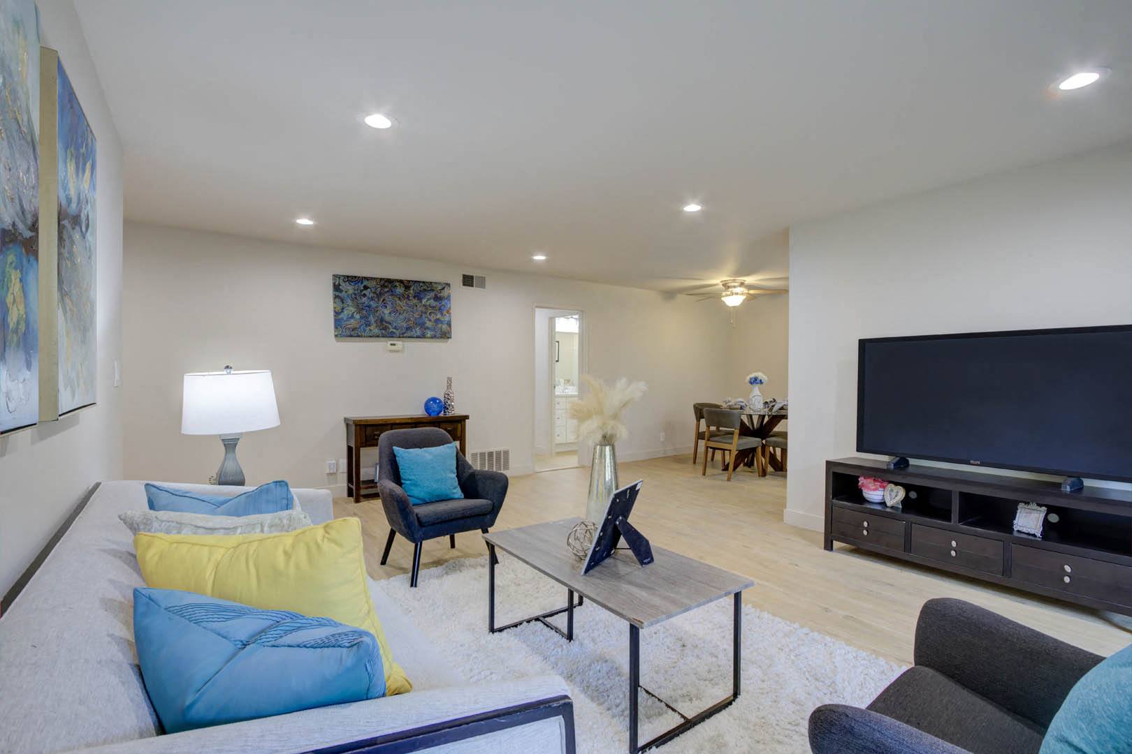 a living room filled with furniture and a flat screen tv