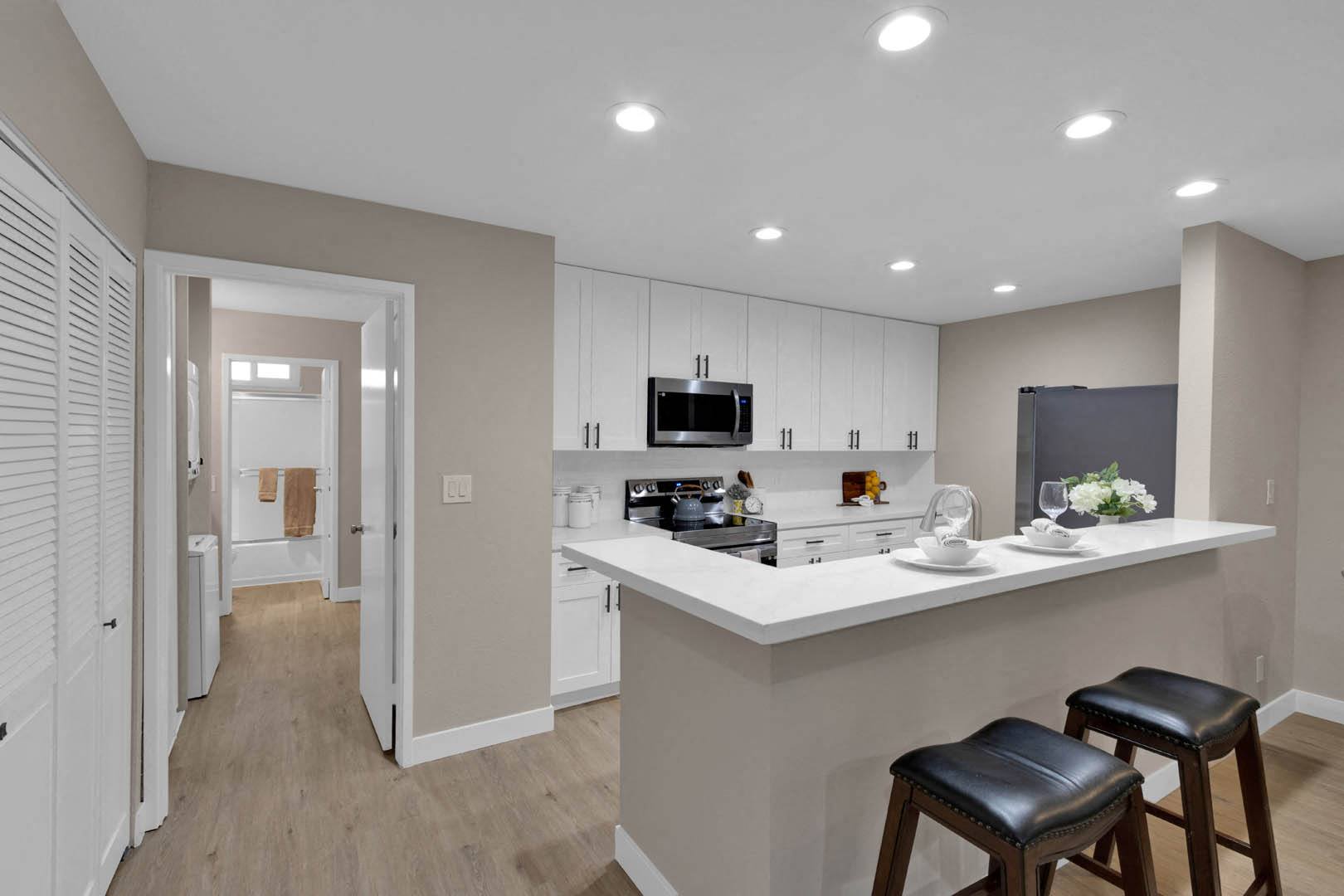 a kitchen with an island and two stools