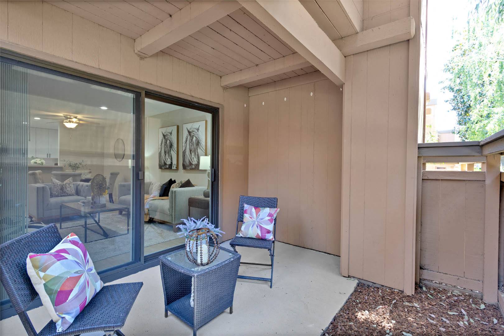 a patio with two chairs and a table
