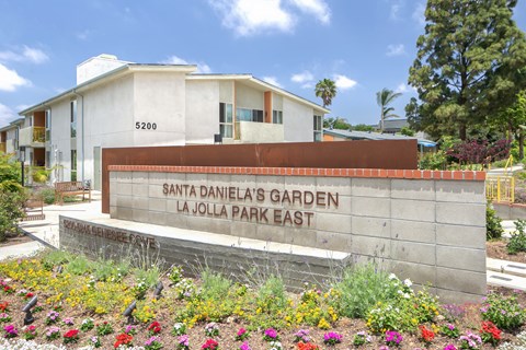 a sign for the parks garden in front of a building