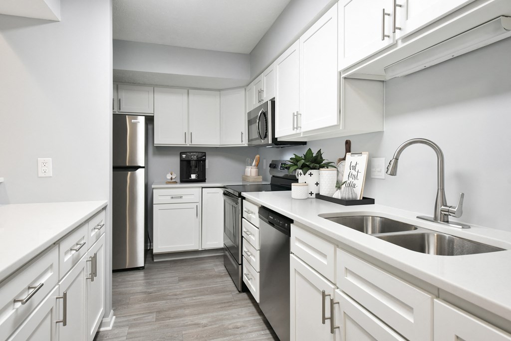 kitchen with all white cabinets, stainless steel appliances and breakfast bar at The Donovan Apartment Homes, Lincoln, NE, 68516