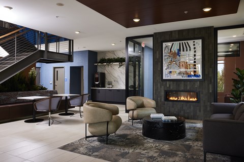 A living room with a fireplace and a painting on the wall.