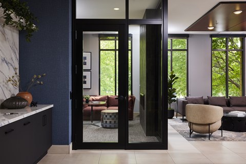 A modern living room with a glass door entrance.