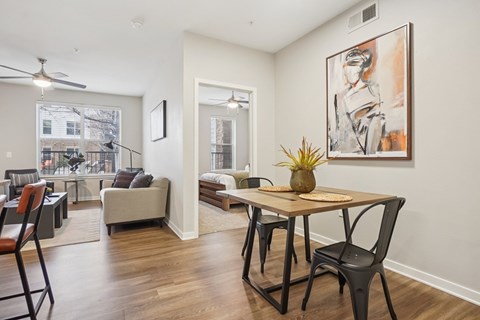 A living room with a dining table and chairs.