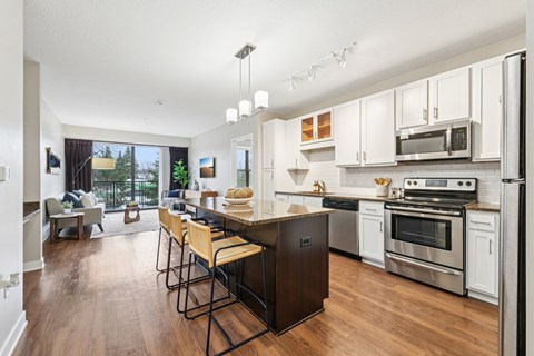 A modern kitchen with a dining table and chairs.