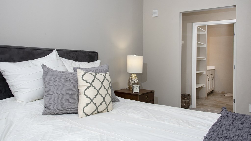 a bedroom with a white bed and pillows