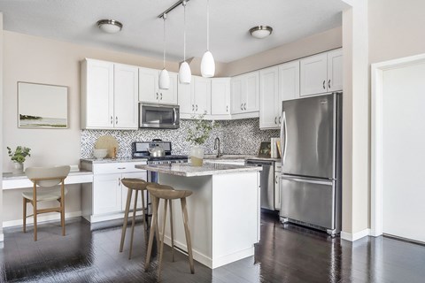 a kitchen with stainless steel appliances and white cabinets