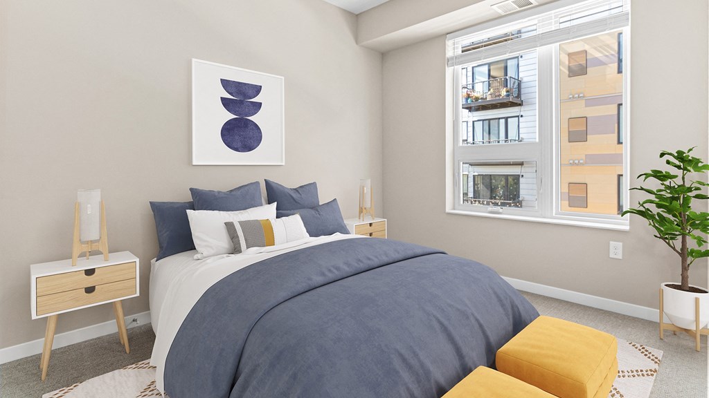 a bedroom with a large bed and a window