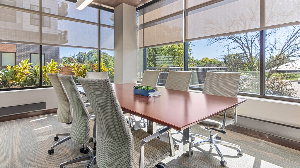 a conference room with large windows and a table with chairs