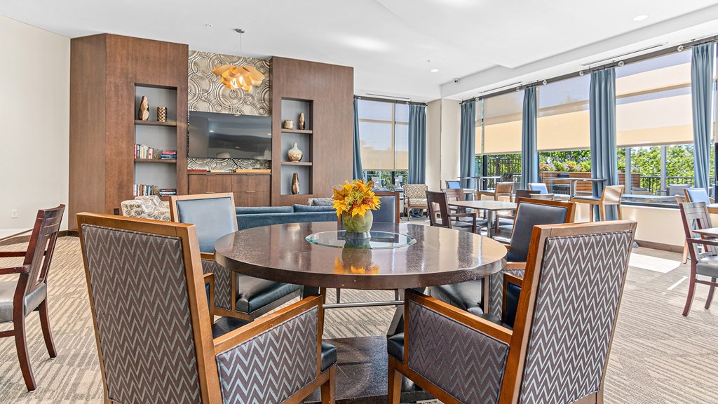 a dining room with tables and chairs and a large window