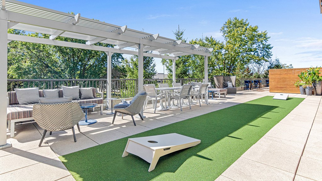 a patio with tables and chairs and a pergola