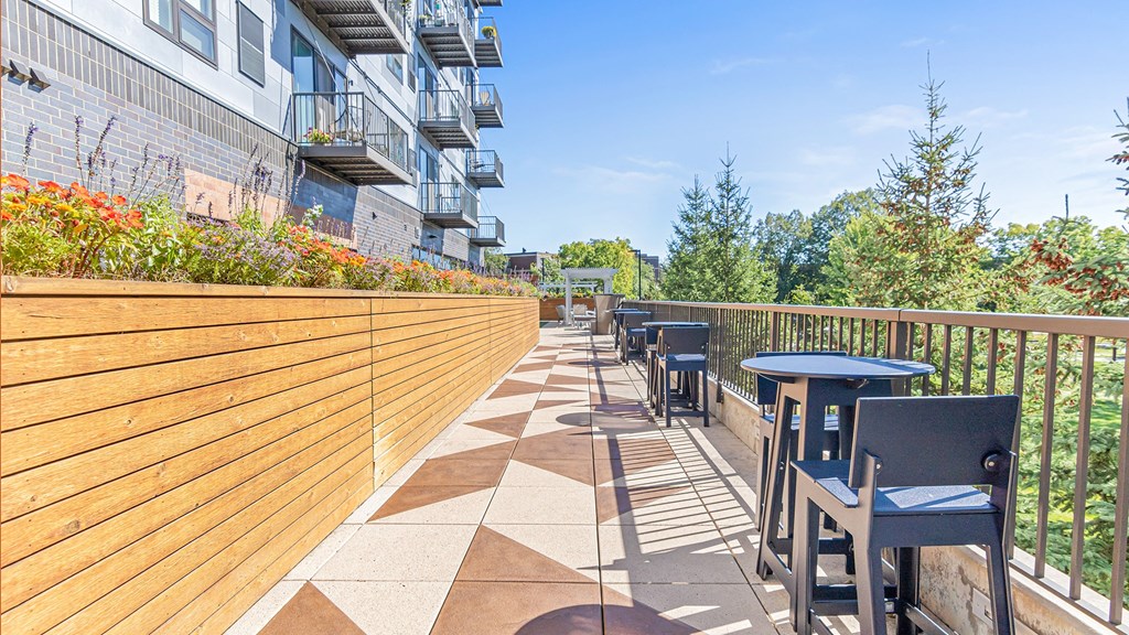 the patio of a building with tables and chairs on it