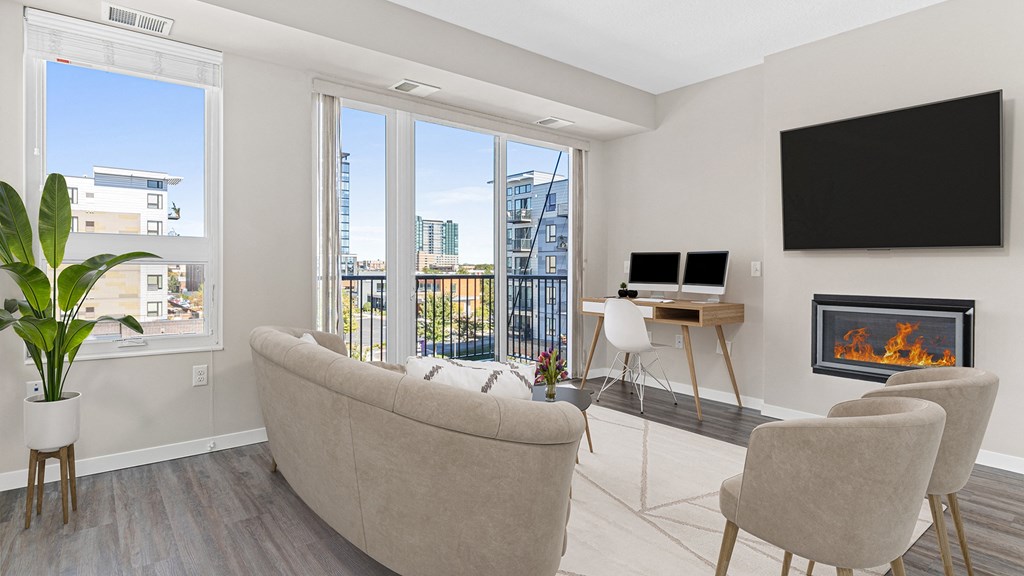 a living room with a couch and a desk and a fireplace