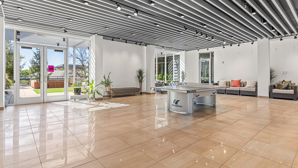 a large living room with a pool table in the middle of it