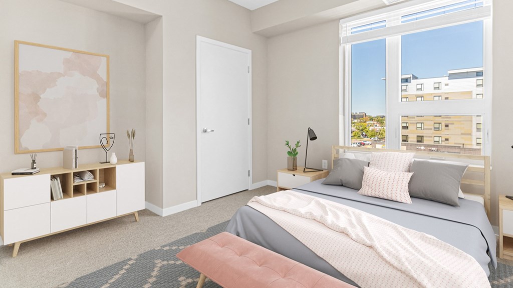 a bedroom with a bed and a large window