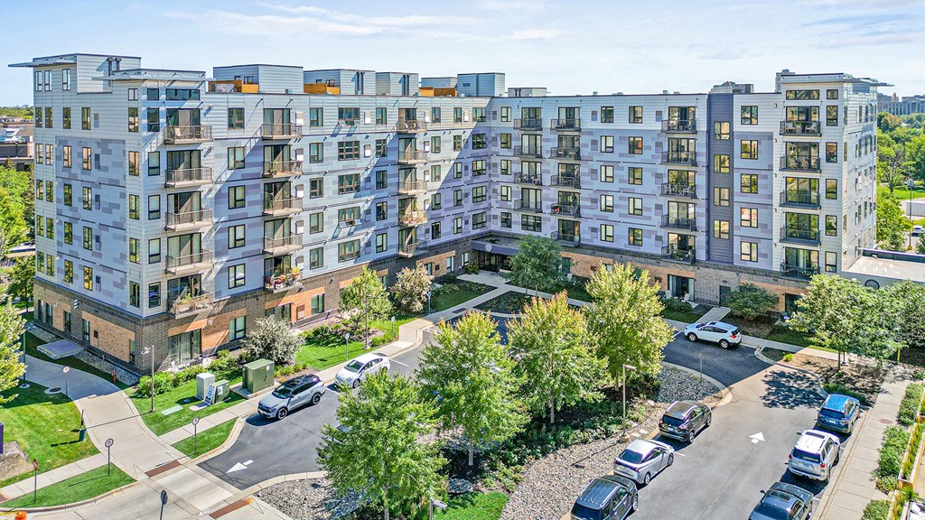 an aerial view of an apartment building on a city street