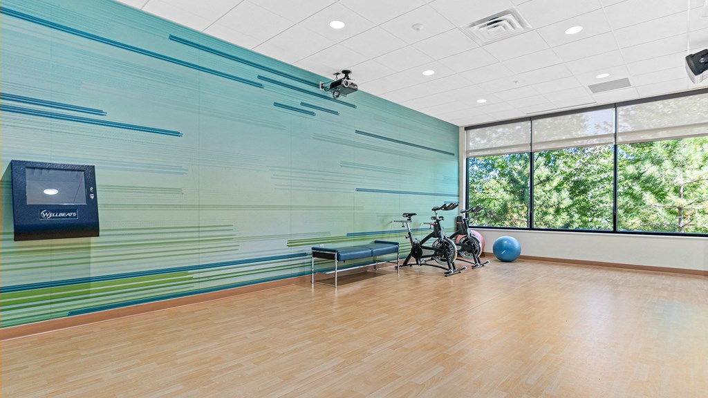 a large room with a large window and a table and chairs in it