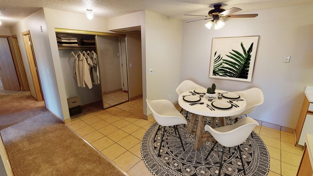Dining Room with Circular Table and Rug, Coat Closet