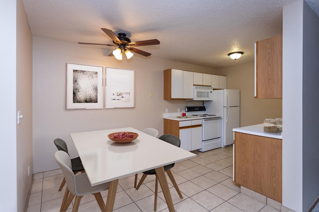 Kitchen with White Cabinets and Open Dining Room with Table