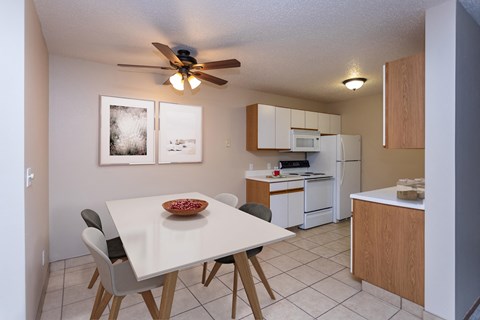 Kitchen with White Cabinets and Open Dining Room with Table