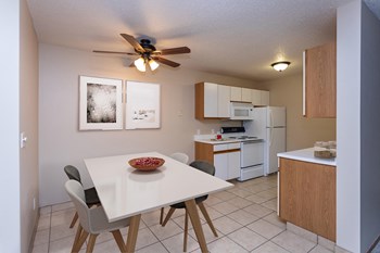 Kitchen with White Cabinets and Open Dining Room with Table - Photo Gallery 3