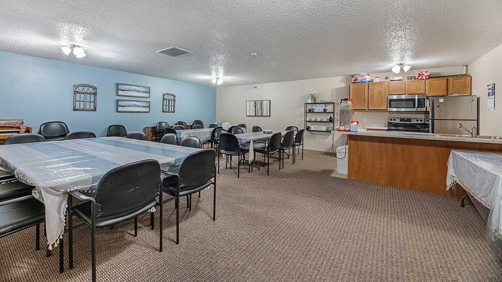 a dining room with a table and chairs and a kitchen