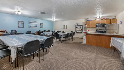 a dining room with a table and chairs and a kitchen