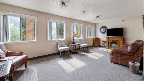 a living room with a couch and chair and a fireplace