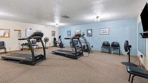 our gym has plenty of exercise equipment and chairs for residents to use