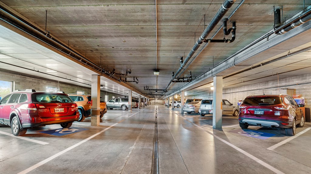 an empty parking garage with cars parked in it