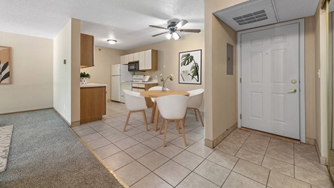 a dining room with a table and chairs and a kitchen