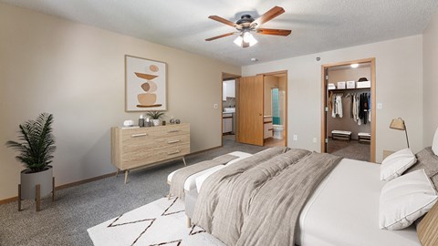 a bedroom with a large bed and a ceiling fan