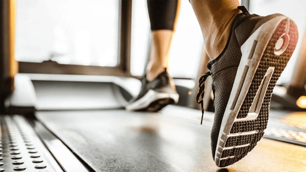 a woman running on a treadmill in the gym