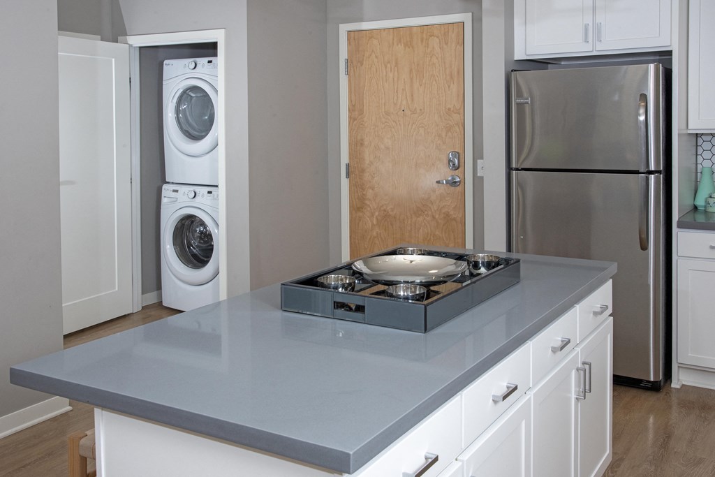 In unit stacked washer dryer in convenient closet off the kitchen.