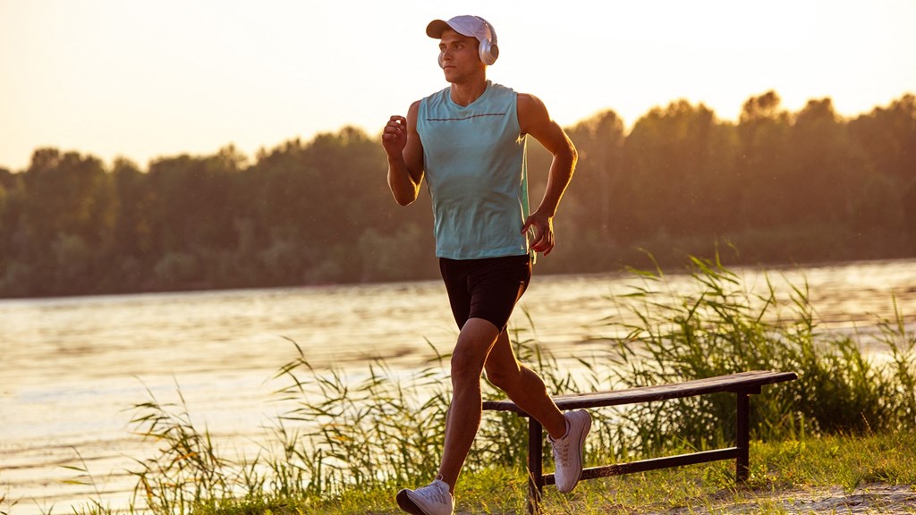a man running next to a body of water