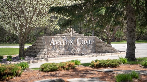 a sign for avlon cove on the side of a road