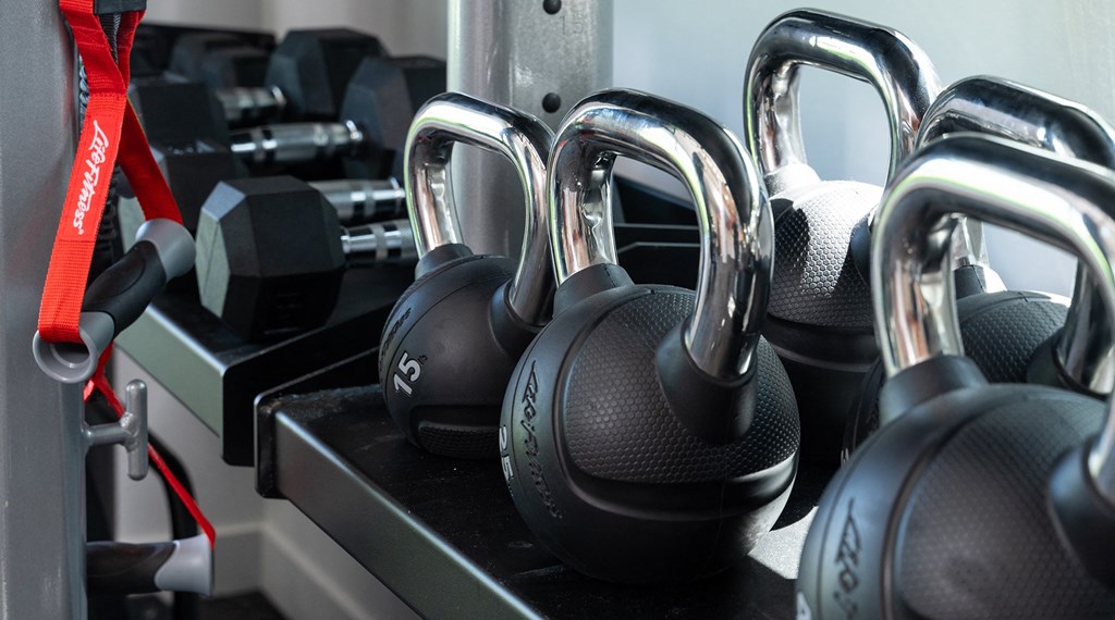 a group of headphones on a docking station in a gym
