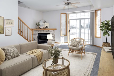 a living room with a couch and a chair and a fireplace