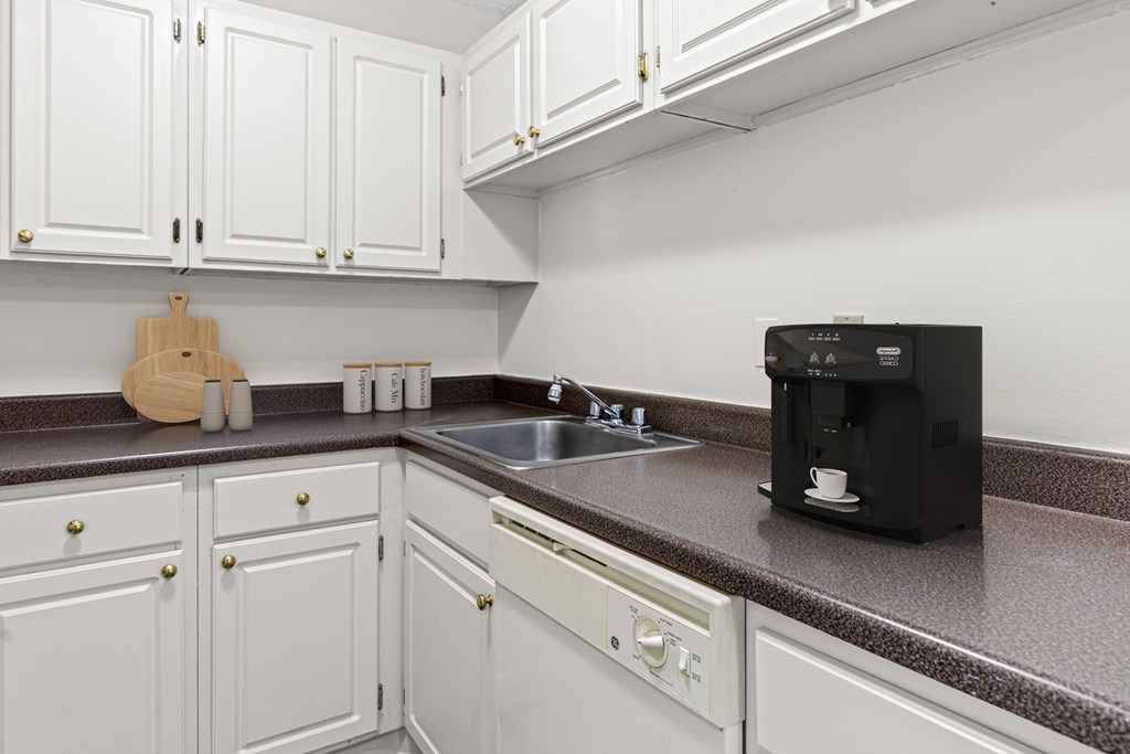 A black coffee maker on a kitchen counter.