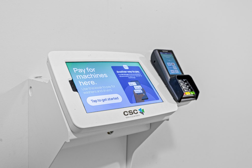 A payment machine with a screen and a phone on it.