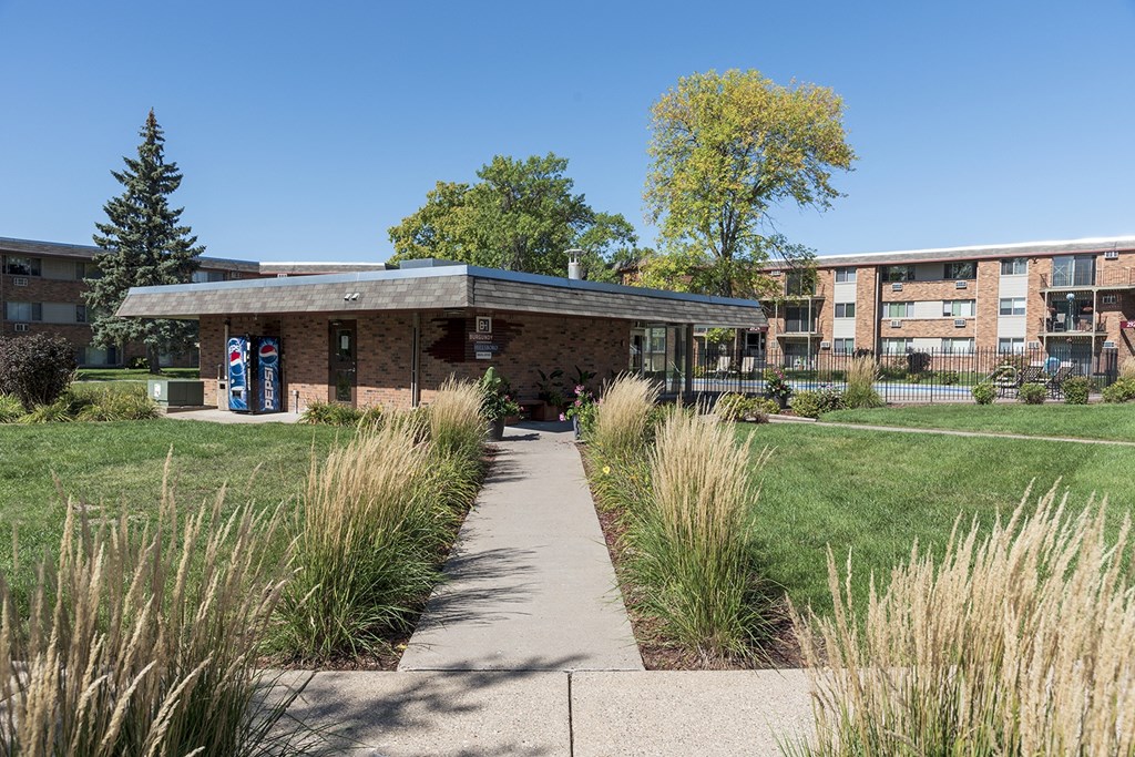 a small building with a sidewalk in front of it