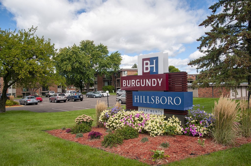 a sign in front of a parking lot